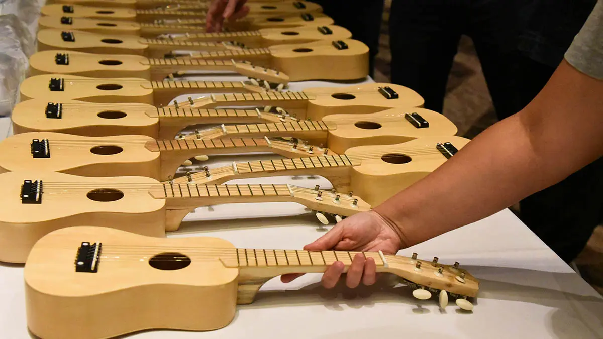 Team members take part in a hands-on musical workshop